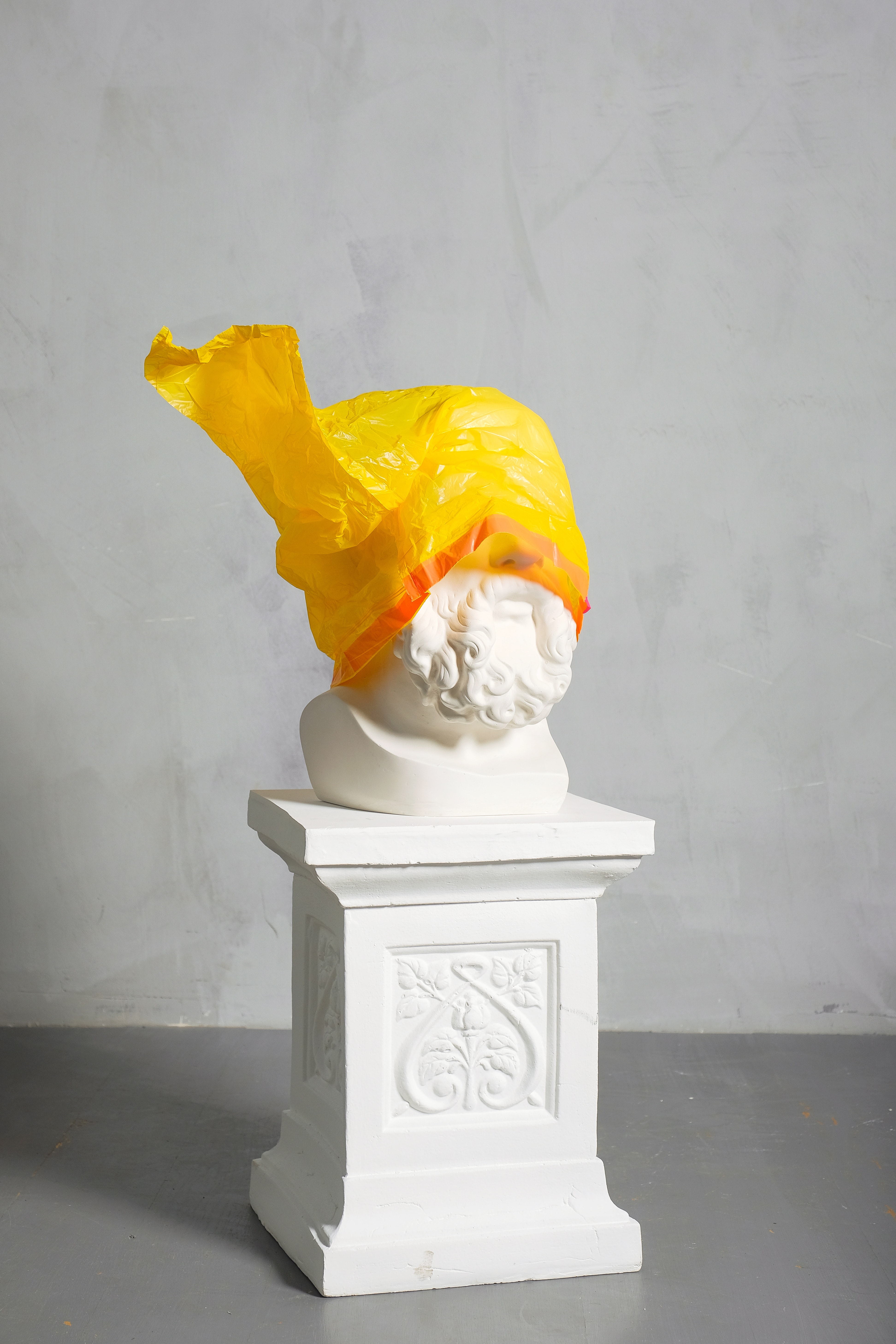 sculpture-covered-yellow-plastic-on-white-background-3683187
